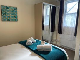 A bedroom with a bed and decorative wall art at Mutiny House Brewers Quay Harbour