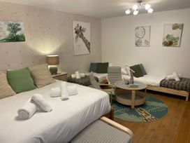 A bedroom with multiple beds and decorative art at The Oast House in Brewers Quay Harbour
