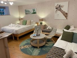A bedroom with beds and a table at The Oast House in Brewers Quay Harbour