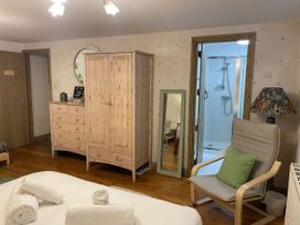 A bedroom with a wardrobe and chest of drawers at The Oast House in Brewers Quay Harbour
