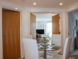 A dining area with a glass table and chairs at Estuary View in Kingsbridge