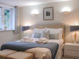 A bedroom with a bed and bedside tables at Estuary View in Kingsbridge