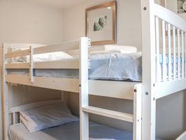 A bunk bed with white bedding at Estuary View in Kingsbridge