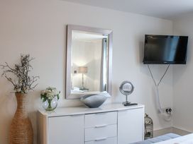 A bedroom with a television and dresser at Estuary View in Kingsbridge