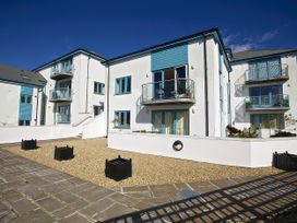 An outdoor area with modern buildings and planters at Estuary View in Kingsbridge