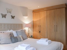 A bedroom with a bed and storage unit at Estuary View in Kingsbridge