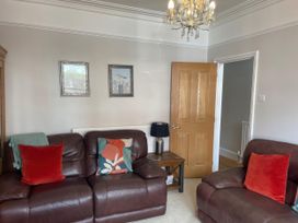 A living room with a sofa and armchair at Pedaller's Cottage in Weymouth