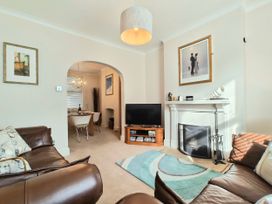 A living room with a sofa and television at Quay Cottage in Weymouth