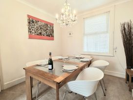 A dining room with a table set for six at Quay Cottage in Weymouth