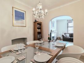 A dining room with a table set for dinner at Quay Cottage in Weymouth