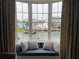 A window with cushions overlooking the harbor at Safe Harbour Brewers Quay harbour