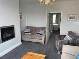 A living room with a sofa and fireplace at Safe Harbour in Brewers Quay harbour