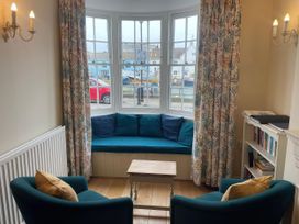 A living room with a couch and table at Safe Harbour Brewers Quay harbour