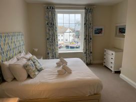 A bedroom with a bed and window view at Safe Harbour in Brewers Quay harbour