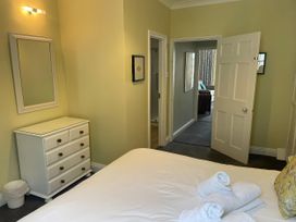 A bedroom with a bed and dresser at Safe Harbour in Brewers Quay harbour