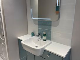 A bathroom with a sink and mirror at Safe Harbour in Brewers Quay harbour
