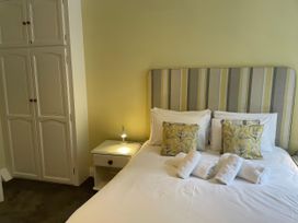A bedroom with a bed and pillows at Safe Harbour, Brewers Quay harbour