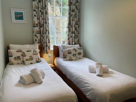 A bedroom with two beds and a window at Safe Harbour in Brewers Quay harbour