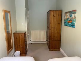 A bedroom with a wardrobe and chest of drawers at Safe Harbour in Brewers Quay harbour