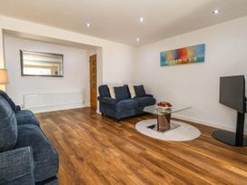 A living room with a sofa and a coffee table at Tides Corner in Bowleaze