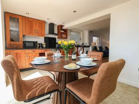 A dining room with a table set for meals at Tides Corner in Bowleaze