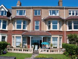 A building with multiple windows and a door at Weymouth Bay Apartment C in Greenhill