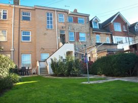 A garden with a building and stairs at Weymouth Bay Apartment C in Greenhill