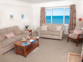 A living room with a view of the sea at Weymouth Bay Apartment C in Greenhill
