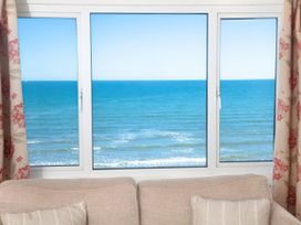 A view of the ocean from a window in a living room at Weymouth Bay Apartment C in Greenhill