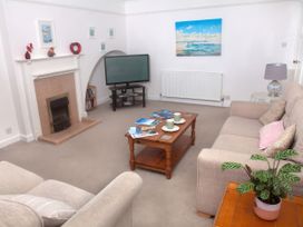 A living room with a television and a coffee table at Weymouth Bay Apartment C in Greenhill