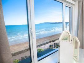 A window view of the ocean with a mirror at Weymouth Bay Apartment C in Greenhill