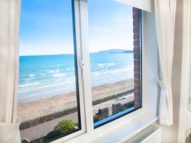A view of the sea and beach from a window at Weymouth Bay Apartment C Greenhill