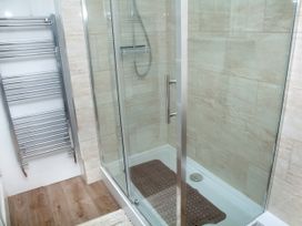 A shower enclosure with towel rail at Weymouth Bay Apartment C in Greenhill