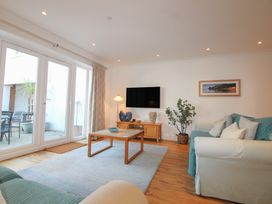A living room with a coffee table and television at 16 Bolt Head Salcombe