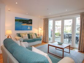 A living room with a sofa and coffee table at 16 Bolt Head in Salcombe