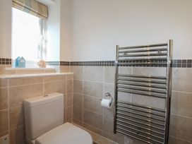 A bathroom featuring a toilet, towel rail, and window at 16 Bolt Head Salcombe