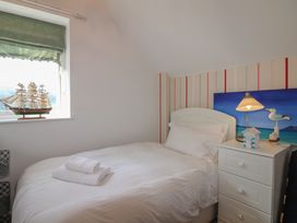 A bedroom with a single bed and model ship at 16 Bolt Head Salcombe
