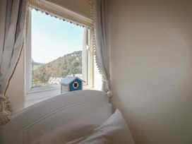 A bedroom with a window and a bed at 16 Bolt Head in Salcombe