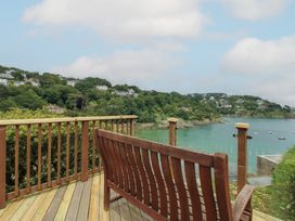 A view of a coastal landscape with a wooden bench at 16 Bolt Head Salcombe