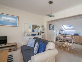 A living room with a sofa and dining area at 19 Bolt Head Salcombe