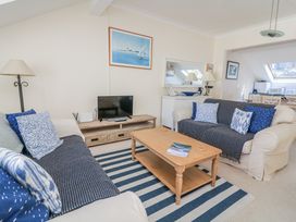 A living room with a sofa and coffee table at 19 Bolt Head in Salcombe