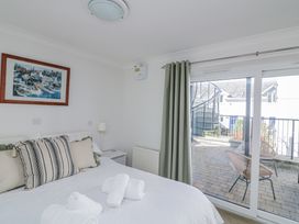 A bedroom with a bed and a view to outside at 19 Bolt Head Salcombe