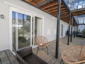 An outdoor area with sliding doors, chairs, and a table at 19 Bolt Head Salcombe