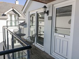 A balcony with a table and chairs at 19 Bolt Head in Salcombe