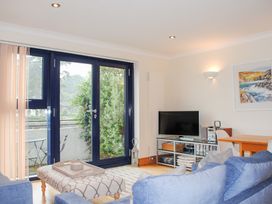 A living room with a sofa and television at 1 Crabshell Quay in Kingsbridge