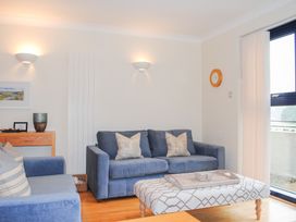 A living room with a sofa and coffee table at 1 Crabshell Quay in Kingsbridge
