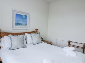 A bedroom with a bed and picture at 1 Hazeldene in Salcombe
