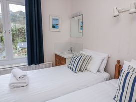 A bedroom with two beds and a sink at 1 Hazeldene in Salcombe