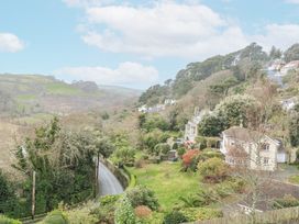 A view of houses and trees on a hillside at 1 Hazeldene in Salcombe