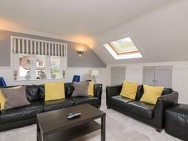 A living room with sofas and a coffee table at 1 The Old Coach House in Dartmouth